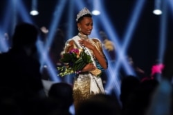 FILE - Zozibini Tunzi of South Africa takes her first walk as Miss Universe after winning the 2019 Miss Universe pageant at Tyler Perry Studios in Atlanta, Georgia, Dec. 8, 2019.