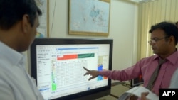 FILE - A Pakistani team member of Met Office's Tsunami Early Warning Center collects real time data on a computer from Indonesian, Australian and Indian centers in Karachi, Sept. 10, 2014.