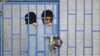 A patient looks from behind bars at a psychiatric hospital during a ceremony marking the World Mental Health Day in Sanaa, Yemen October 10, 2019. 