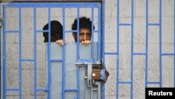 A patient looks from behind bars at a psychiatric hospital during a ceremony marking the World Mental Health Day in Sanaa, Yemen October 10, 2019. 