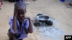 FILE - A displaced Somali child sits on May 24, 2017 at a makeshift camp in the Garasbaley area on the outskirts of the capital Mogadishu, where people converge after fleeing their homes due to the dire drought that has hit the country. 