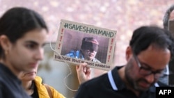 FILE - A demonstrator holds a picture of Iranian-German Jamshid Sharmahd with the lettering "Save Sharmahd" and "German politics has to act" during a demonstration for his release in front of the German Foreign Ministry in Berlin on July 31, 2023.