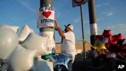 En esta foto de archivo del 6 de agosto de 2019, un hombre coloca un cartel de "El Paso Strong" (Fuerza El Paso) en un monumento improvisado a las víctimas de la masacre de El Paso, Texas. (AP Foto/John Locher, Archivo)