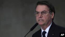 FILE - Brazil's President Jair Bolsonaro speaks at Planalto presidential palace in Brasilia, March 25, 2019.