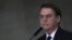 Brazil's President Jair Bolsonaro speaks at Planalto presidential palace in Brasilia, March 25, 2019. Bolsonaro's administration is considering a dramatic change in the council that oversees Brazil’s environmental policy.