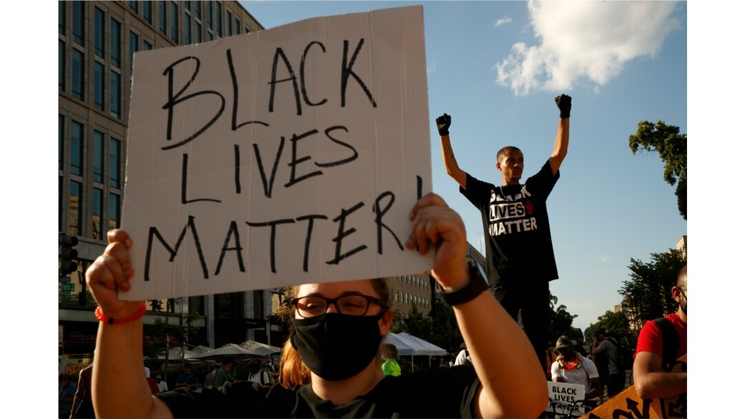 FILE - Antonio Mingo, right, holds his fists in the air as demonstrators protest on a section of 16th Street renamed Black Lives Matter Plaza, in Washington, June 24, 2020. The Black National Convention will be held Aug. 28, 2020.