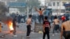 Iraqi demonstrators clash with Iraqi security forces during a protest over poor public services in Baghdad