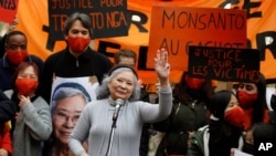 Tran To Nga, a 78-year-old former journalist, waves as she delivers a speech during a gathering in support of people exposed to Agent Orange during the Vietnam War, in Paris, Jan. 30, 2021.