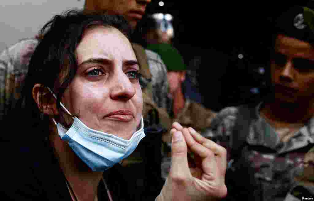 A woman reacts as members of security forces attempt to evict displaced people from an old hotel, amid ongoing hostilities between Hezbollah and Israeli forces, in the Hamra neighborhood of Beirut, Lebanon, Oct. 21, 2024.&nbsp;