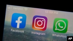 This Tuesday, Oct. 5, 2021 file photo shows the mobile phone app logos for, from left, Facebook, Instagram and WhatsApp in New York. (AP Photo/Richard Drew, File)