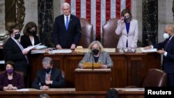 U.S. Vice President Mike Pence and Speaker of the House Nancy Pelosi (D-CA) prepare to read the final certification of Electoral College votes cast in November's presidential election during a joint session of Congress after working through the night, at the Capitol in Washington