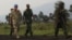 U.N. Deputy Force Commander in Congo, General Adrian Foster, left, of Britain, visits the area where M23 rebels fought with Congo government troops close to the eastern city of Goma, July 29, 2012.