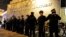 FILE - Chicago police officers line up outside the District 1 central headquarters during a protest of a police shooting in Chicago, Nov. 24, 2015.
