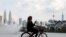 A woman rides a bicycle at a park, amid the coronavirus disease (COVID-19) pandemic, in Kuala Lumpur, Malaysia, Sept. 27, 2021. 