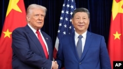 资料照片：美国总统唐纳德·特朗普与中国国家主席习近平2025年10月30日在韩国釜山会面前握手。