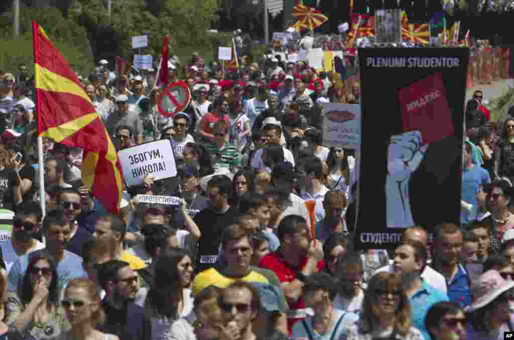 Protesters holding Macedonian flags and banners reading &quot;Resignation&quot; and &quot;Goodbye Nikola&quot; while they march towards the offices of Macedonia&#39;s conservative government in capital Skopje, May 17, 2015.