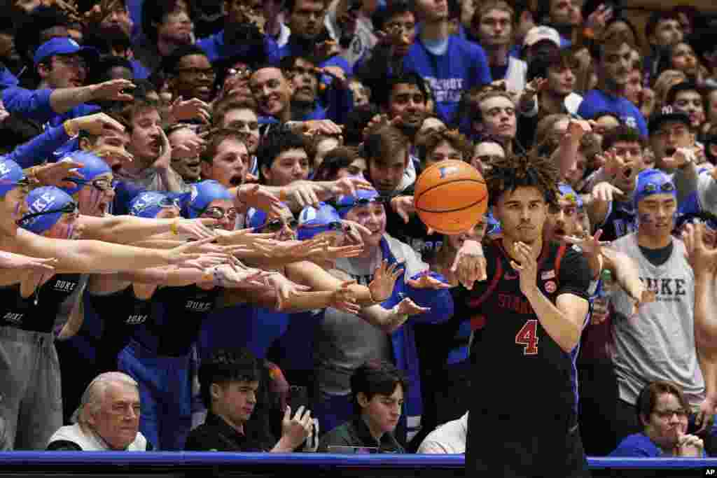 Supporters from Cameron Crazies student section try to distract Stanford's Oziyah Sellers's as he in-bounds the ball during the second half of an NCAA college basketball game against Duke in Durham, North Carolina, Feb. 15, 2025.