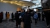 FILE - Shoppers visit a popular mall in Beijing, Dec. 15, 2024. 