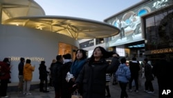 Shoppers visit a popular mall in Beijing, Dec. 15, 2024. 