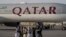 Para kombatan Taliban berjalan melintas di depan pesawat Qatar Airways di Bandara Internasional Kabul, 9 September 2021.