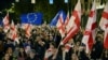 Protesters wave flags during a pro-Europe rally ahead of the parliamentary elections, which are seen as a crucial test for the country's democracy and its bid for EU membership, in Tbilisi on Oct. 20, 2024. 