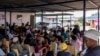 A health worker promotes awareness and early detection of, and screening for gender-related cancers during the screening day at the Lawley 2 Clinic in Lawley, Johannesburg on November 28, 2023.