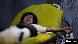 A boy, 12, cries as he lies on a stretcher at a hospital in Sanaa to which he was rushed after he was injured in an airstrike in the northern province of al-Jawf, Yemen, July 15, 2020. 