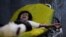 A boy, 12, cries as he lies on a stretcher at a hospital in Sanaa to which he was rushed after he was injured in an airstrike in the northern province of al-Jawf, Yemen, July 15, 2020. 