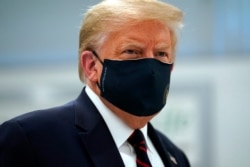 President Donald Trump wears a face mask as he participates in a tour of Bioprocess Innovation Center at Fujifilm Diosynth Biotechnologies, Monday, July 27, 2020, in Morrisville, N.C.