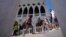Tourists walks on a bridge in front of Palazzo Ducale, in Venice, Italy, Thursday, June 17, 2021. After a 15-month pause in mass international travel, Venetians are contemplating how to welcome visitors back to the picture-postcard canals and…