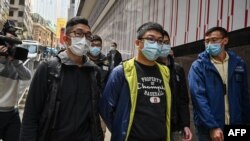 Ben Chung (front C) of a pro-democracy political group is arrested by police in Hong Kong on Jan.6, 2021. As many as 50 Hong Kong opposition figures were arrested under a new national security law.