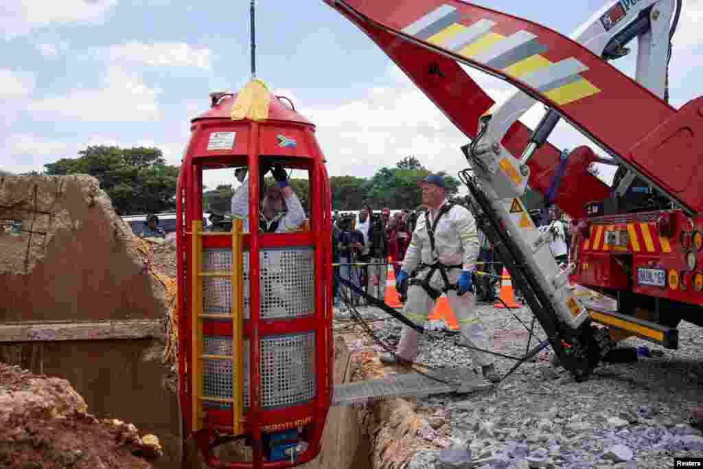 Workers from Mines Rescue Services operate the mechanical cage as authorities say that no miners remain below ground after attempts were made to rescue illegal miners who have been underground for months, in Stilfontein, South Africa.