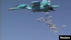 FILE - A still image, taken from video footage and released by Russia's Defence Ministry, Aug. 18, 2016, shows a Russian Sukhoi Su-34 fighter-bomber based at Iran's Hamadan air base, dropping bombs in the Syrian province of Deir Ezzor. 