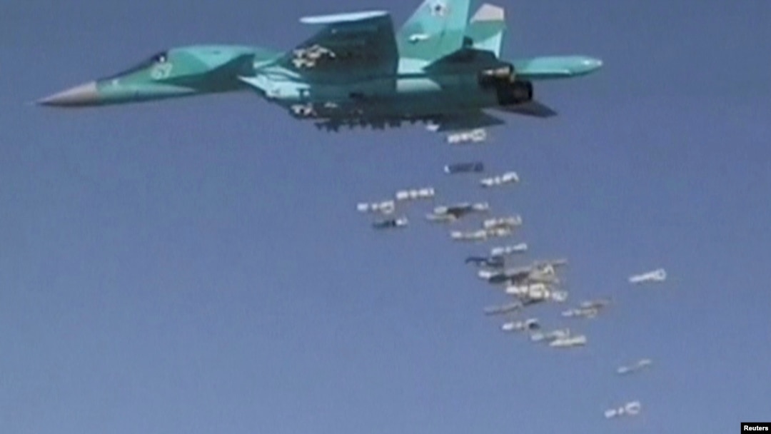 FILE - A still image, taken from video footage and released by Russia's Defense Ministry on Aug. 18, 2016, shows a Russian Sukhoi Su-34 fighter-bomber dropping bombs in the Syrian province of Deir ez-Zor. 