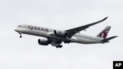 FILE - A Qatar Airways jet approaches Philadelphia International Airport in Philadelphia, Nov. 7, 2019. On Sept. 24, 2024, Qatar became the second Muslim-majority nation to join the U.S.'s visa waiver program. 