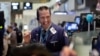 FILE - A trader is seen working on the floor of the New York Stock Exchange.