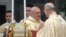 Pope Francis greets Secretary of State Cardinal Tarcisio Bertone (r) as he celebrates his inaugural Mass with cardinals, inside the Sistine Chapel, at the Vatican, March 14, 2013. 