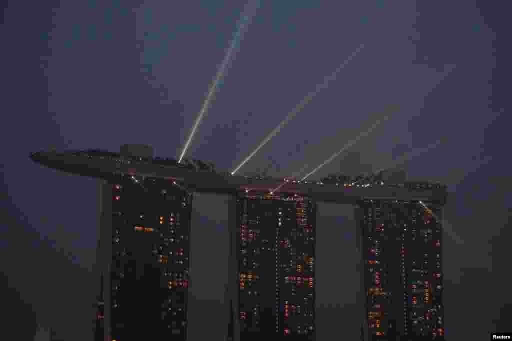 A laser light show plays froaA laser light show plays from the top of the Marina Bay Sands integrated resort amid haze in Singapore. the top of the Marina Bay Sands integrated resort during haze in Singapore.