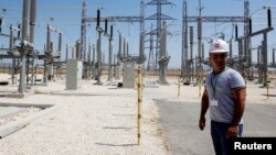 An Israeli engineer stands at an electrical substation near the West Bank city of Jenin, July 10, 2017. 