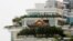 A privately-built illegal temple-like structure is seen on the top of a 20-story residential block in the southern Chinese city of Shenzhen, August 22, 2013. 