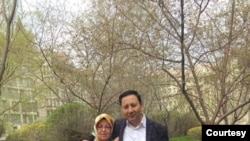 This picture shows Yahya Kurban and Amina Kurban standing in the garden of their apartment complex in Urumqu, the capital city of Xinjiang, China. (Photo courtesy Hankiz Kurban)