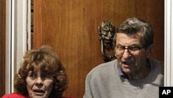 Joe Paterno and his wife, Susan, come to the doorway of their home to thank supporters gathered outside their home after John Surma, chairman and chief executive officer, announced the firing of Paterno as head football coach, November 9, 2011.