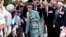 FILE - Queen Elizabeth (C) receives flowers and letters from the public as she walks with the Duke of Edinburgh (center rear) following a ceremony honoring World War II veterans in Wellington, New Zealand, Nov. 5, 1995.