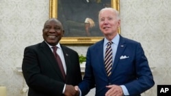 FILE - US President Joe Biden shakes hands with South African President Cyril Ramaphosa as they meet in the Oval Office of the White House, Friday, Sept. 16, 2022, in Washington. South Africa is an active partner in the African Growth and Opportunity Act.