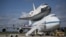 Workers pose for a photograph on the wing of NASA's Shuttle Carrier Aircraft, with the space shuttle Endeavour mated on top, at the Kennedy Space Center in Cape Canaveral, Florida, September 18, 2012.