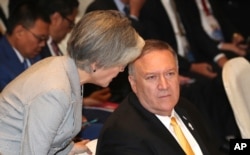 South Korea's Foreign Minister Kang Kyung-wha, left, talks to U.S. Secretary of State Mike Pompeo before the East Asia Summit meeting in Bangkok, Thailand, Aug. 2, 2019.