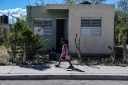 A girl walks in Croix des Bouquets, 12.9kms (8 miles) to the northeast of Port-au-Prince, on Dec. 30, 2019.