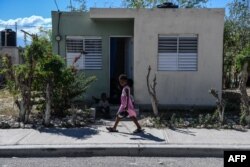 A girl walks in Croix des Bouquets, 12.9kms (8 miles) to the northeast of Port-au-Prince, on Dec. 30, 2019.