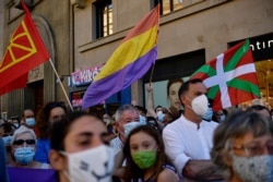 A resident waves a Spanish Republican flag against Spain's former monarch, King Juan Carlos I, in Pamplona, northern Spain, Aug. 5, 2020.