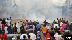 A photo taken on September 28, 2012 in Conkary, Guinea shows youth in the street during the funeral procession for two young opposition supporters killed by police during recent clashes. 